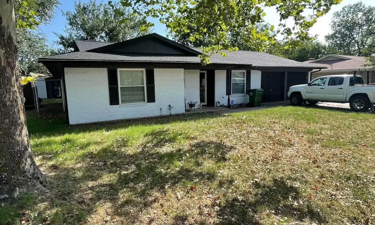Professional roofing crew working on a residential roof in Williamsville